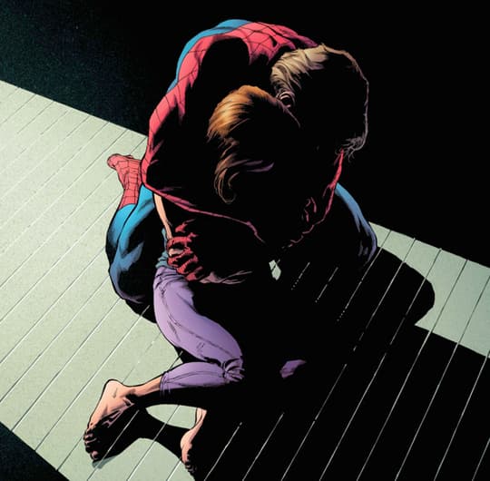 Peter Parker in Spider-Man costume without his mask holds Mary Jane in his arms