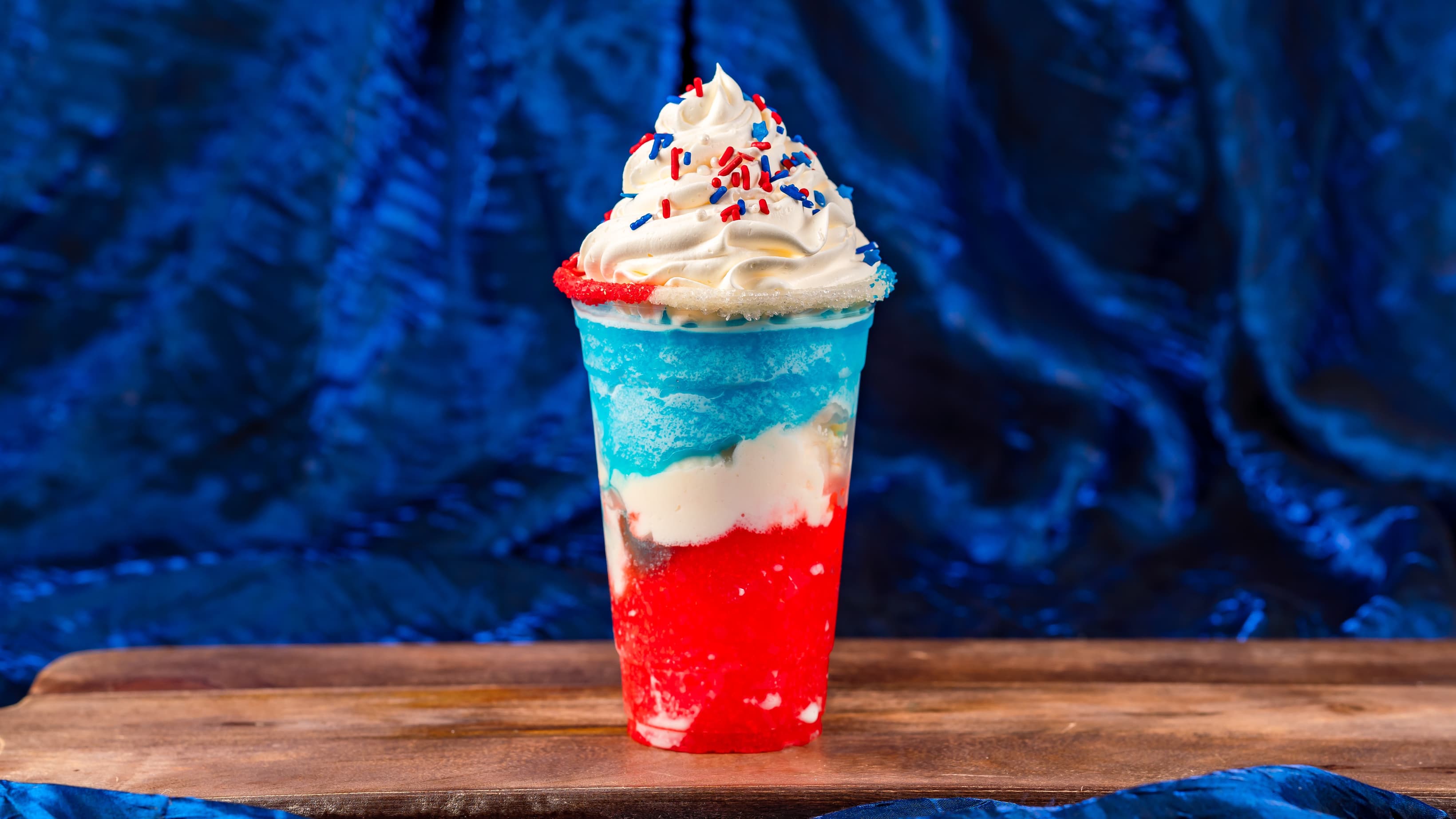Cherry, Vanilla, and Blue Raspberry Shake at Schmoozies: Vanilla shake with wild cherry and blue raspberry slushes and whipped topping (Non-alcoholic)