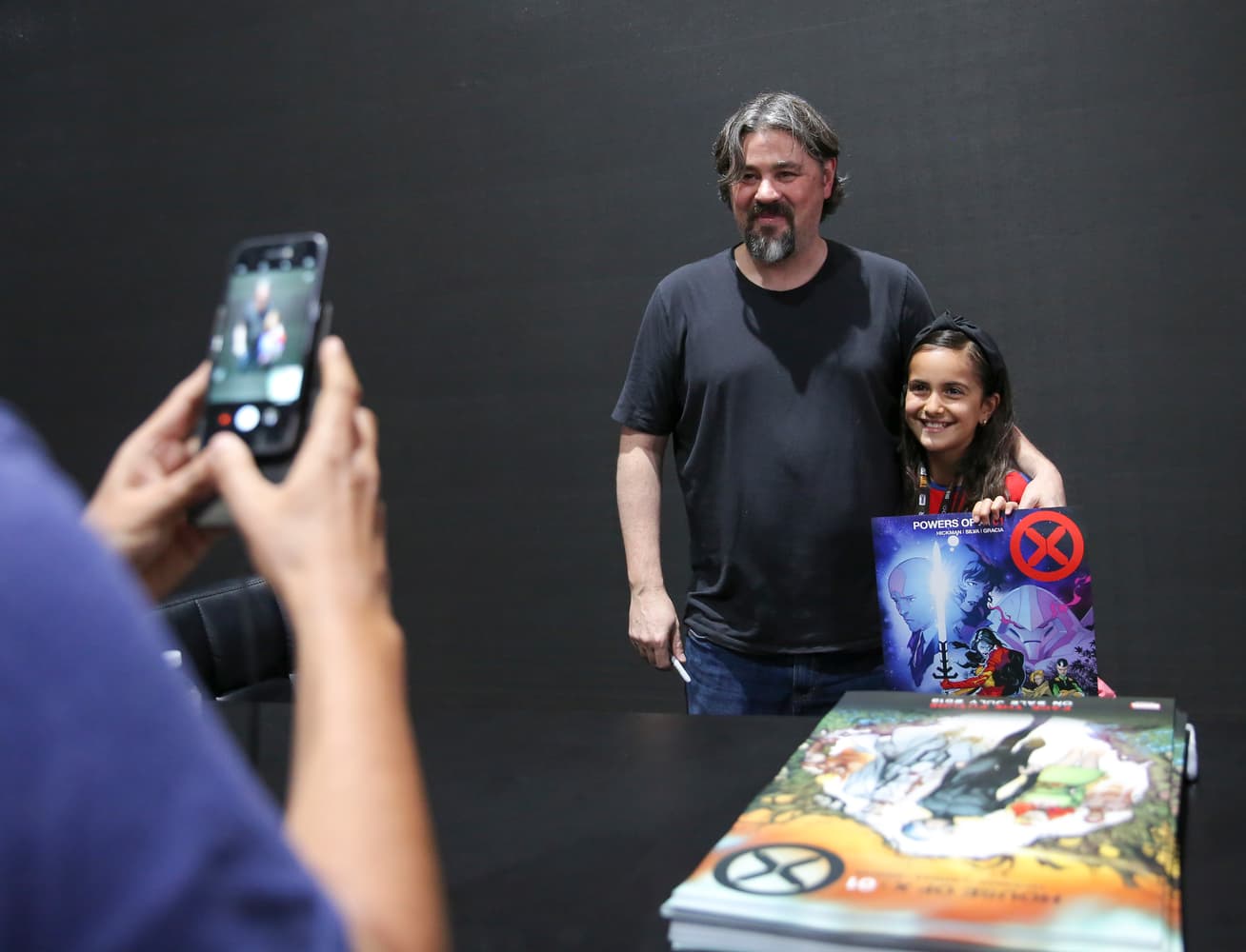 Marvel creator Jonathan Hickman poses with a young fan