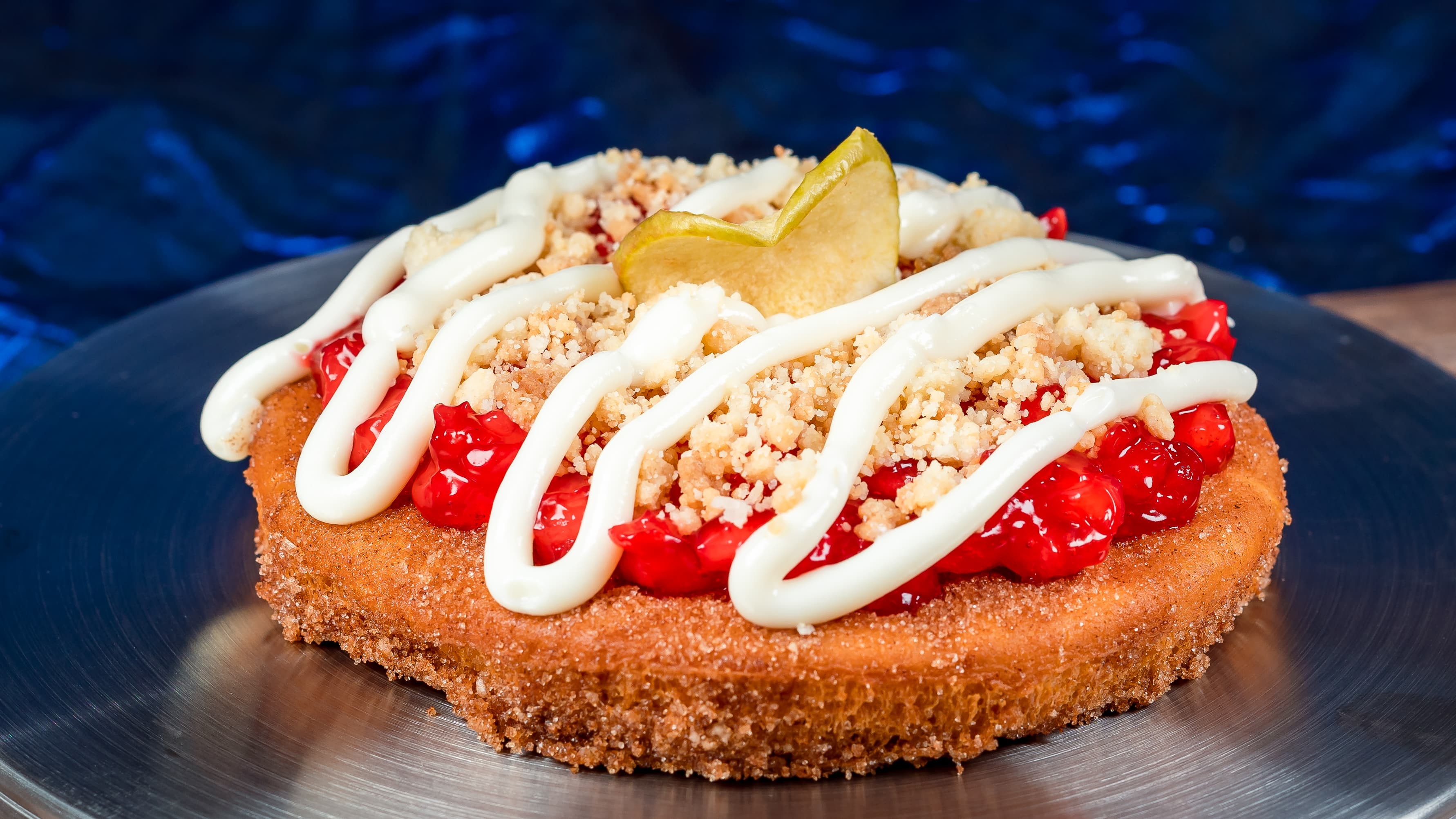 Apple Pizza Pie at Terran Treats: Cinnamon-sugar fried pizza crust topped with apple and cranberry filling, streusel, and cream cheese frosting