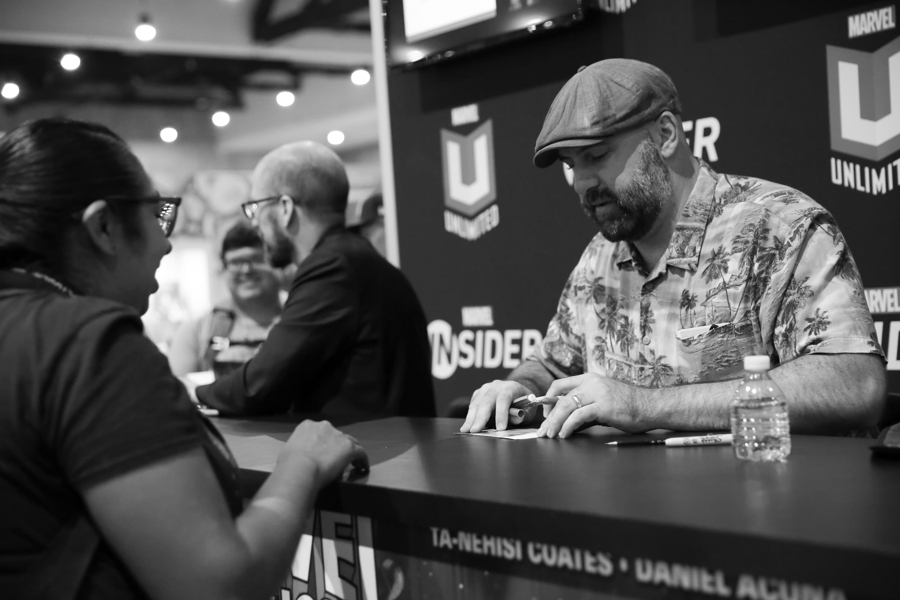 From left to right: Kieron Gillen and Joshua Cassara sign autographs at the Marvel booth