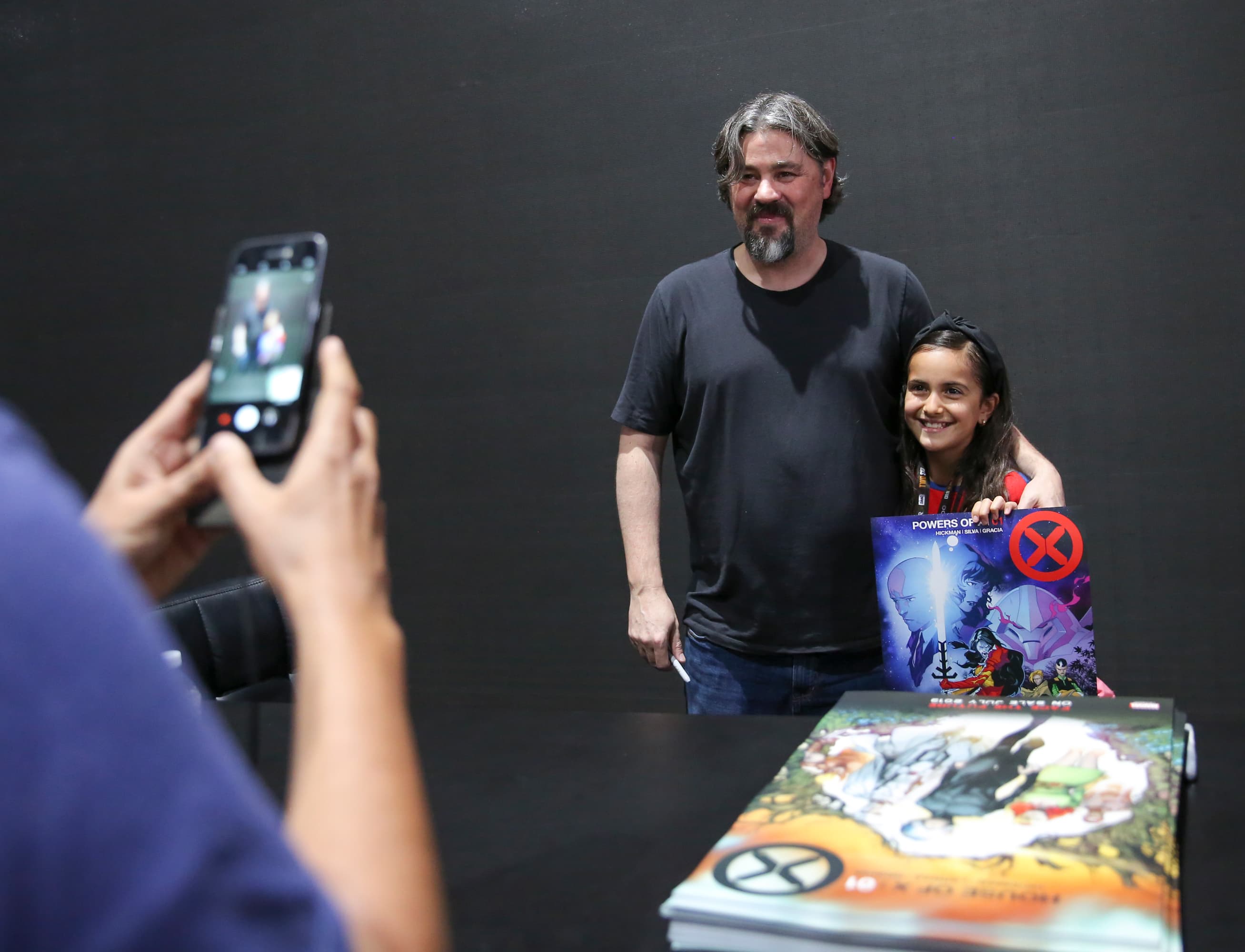 Marvel creator Jonathan Hickman poses with a young fan